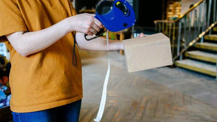 Hand,Of,The,Seller,Using,Labeling,Gun,For,Sticking,Price