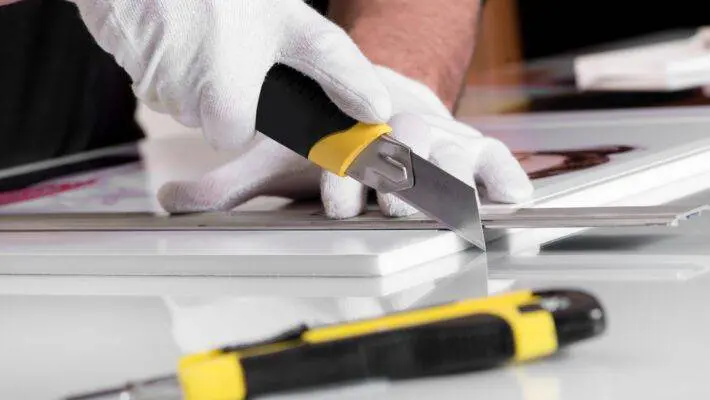 Professional,Hands,In,Gloves,Cutting,Off,Edges,Of,Printed,Photography