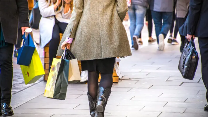 A,Shopping,High,Street,Scene,With,Woman,Carrying,Shopping,Bag