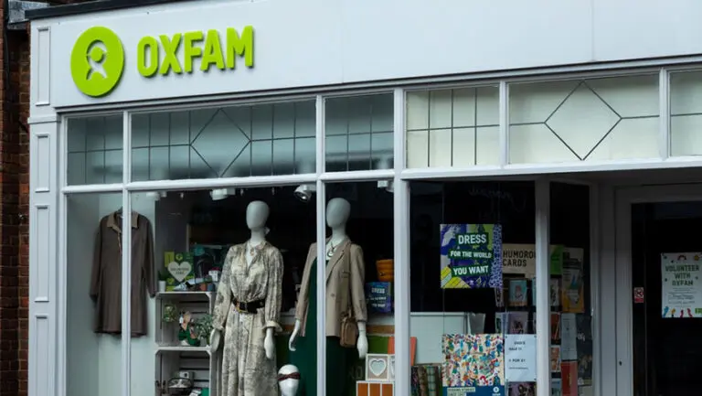 Oxfam is reviewing the operations of its three UK warehouses and has said it "cannot give guarantees" on the future of its high street shops, citing a "difficult economic climate".