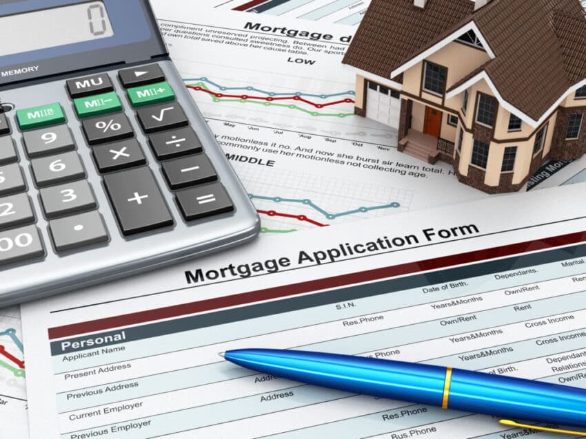 Mortgage application form with a calculator and house.