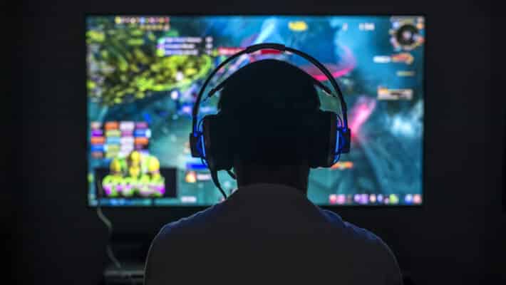 Young,Gamer,Playing,Video,Game,Wearing,Headphone.
