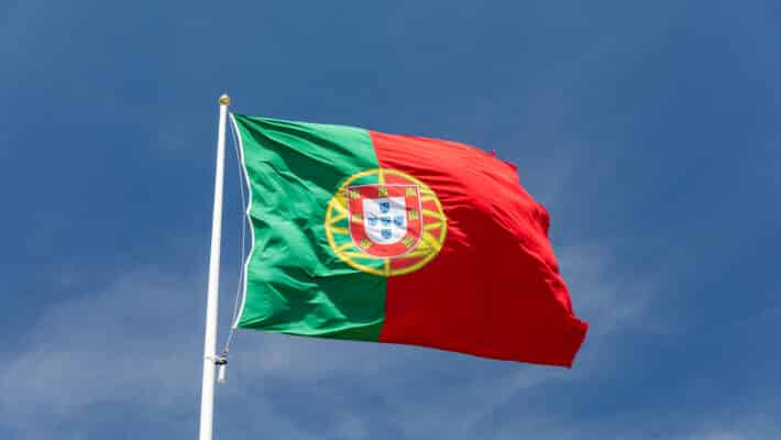 Beautiful,Large,Portuguese,Flag,Waving,In,The,Wind,Against,Blue