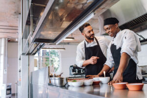 Restaurants and hotels in tourist resorts are paying thousands of pounds in golden handshakes to attract chefs from India and South Africa amid extreme staff shortages.