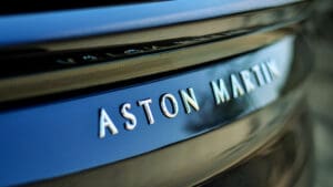 Aston Martin shares slid after the company revealed it would deliver fewer cars than expected this year as it struggled to source certain parts due to supply chain problems.