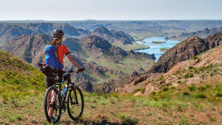 A,Traveler,Guy,On,A,Bicycle,Looks,Out,Over,A